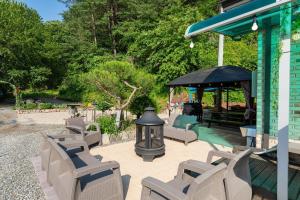 a group of chairs sitting on a patio with a gazebo at Chuncheon Byeol Kkot Soop in Chuncheon +19 photos