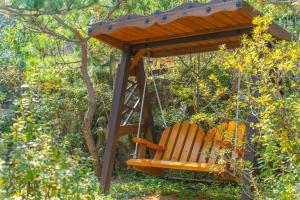 a swing in a garden with a tree at Wa Pension in Ansan +17 photos