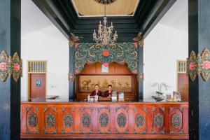 two people sitting at a bar in a room at Royal Brongto Hotel in Yogyakarta