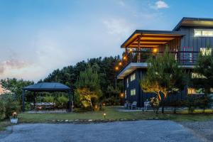 a house with a gazebo in front of it at Morning of Angel Bed and Breakfast Gapyeong in Gapyeong