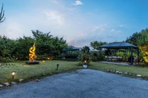 a park with a statue in the middle of a yard at Morning of Angel Bed and Breakfast Gapyeong in Gapyeong