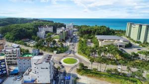 an aerial view of a city with the ocean at Gangneung Nishi Spa Pension in Kyŏngp'o-mal
