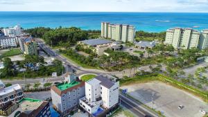 an aerial view of a city with the ocean at Gangneung Nishi Spa Pension in Kyŏngp'o-mal