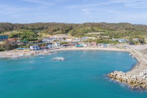 an aerial view of a beach with blue water at Gyeongju Nadeuli Pension in Gyeongju