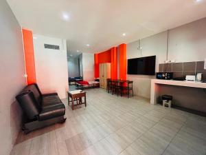 a living room with a chair and a kitchen at KARON STUDIO APARTMENT in Karon Beach