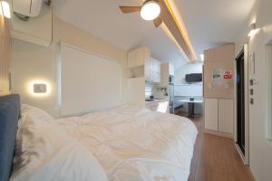 a bedroom with a large white bed in a room at Siheung Wave Park Caravan in Siheung