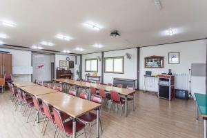 a classroom with tables and chairs in a room at Gangwon Taegisan morning birdsong in Hoengseong
