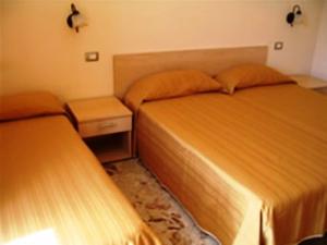 two beds sitting next to each other in a bedroom at Villa Santantonio in Giardini Naxos