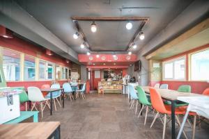 a room with tables and chairs in a restaurant at Riverwalk Pension Chuncheon in Paegyang +17 photos