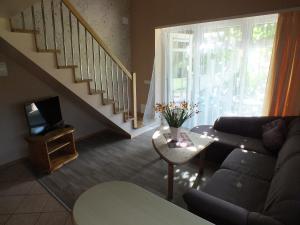 a living room with a couch and a table with a tv at Villa Žvejų 29 in Palanga