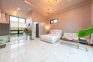 a bedroom with a white bed and a couch at Namiseom 2020 Spa Poolvilla in Chuncheon