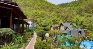 a group of houses with a mountain in the background at Miryang Vitamins in Miryang