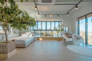 a large living room with a couch and a table at Mazihouse in Donghae