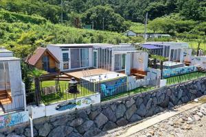 a row of modular homes on a retaining wall at Tongyeong Love the Blue in Tongyeong