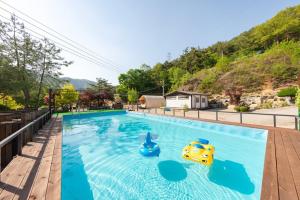 a pool with two toy cars in the water at Inje Naerincheon Glamping in Inje