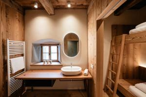 a bathroom with a sink in a room with bunk beds at OBERBUCHFELDER historic farmhouse in Laion +152 photos