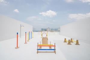 a playground with a row of chairs and a bench at Goseong 072 Stay in Goseong