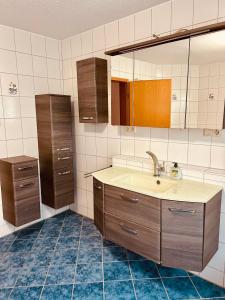 a bathroom with a sink and a mirror at Ferienwohnung Eichel in Rust +26 photos