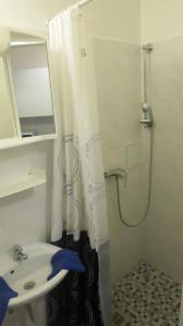 a bathroom with a shower curtain and a sink at Apartments Messe-Prater in Vienna