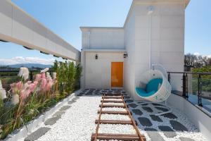 a bathroom with a toilet on the side of a building at Gangneung ST153 in Kyŏngp'o-mal +19 photos