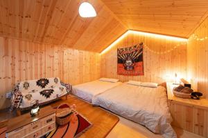 a bedroom with two beds in a wooden room at Gapyeong Starry Night Glamping in Sŏri-gol