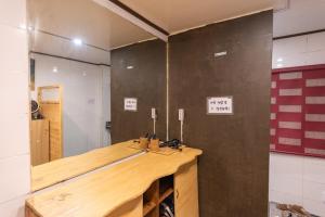 a bathroom with a wooden counter in a room at Gapyeong Starry Night Glamping in Sŏri-gol