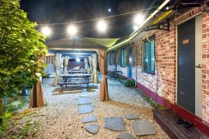 a patio with a table and benches in a building at Page Pension in Inje