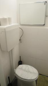 a bathroom with a white toilet with a tank at Apartments Messe-Prater in Vienna