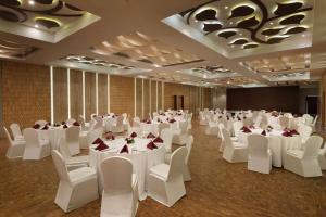a banquet hall with white tables and white chairs at Ramada Resort by Wyndham Kochi in Cochin +91 photos