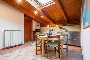 a kitchen with a wooden ceiling and a table and chairs at 7º Cielo Comfort Apartment Venice - Mestre in Venice