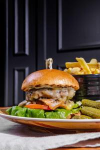 a sandwich on a plate with french fries at DoubleTree by Hilton Hotel Newcastle International Airport in Newcastle upon Tyne