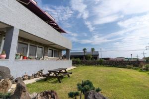 a picnic table in a yard next to a house at Yeonmi Dongsan in Jeju