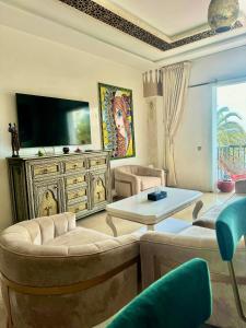 a living room with a couch and a tv at Unforgettable views of Marina Agadir in Agadir