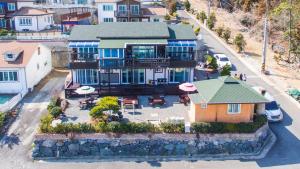 an aerial view of a house with a yard at Geoje Sky Terrace Pension in Geoje