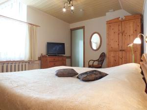 a bedroom with a large bed with two pillows on it at Villa Žvejų 29 in Palanga