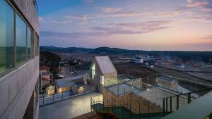 a balcony of a building with a view of a city at Taean Oaten Pool Villa in Taean