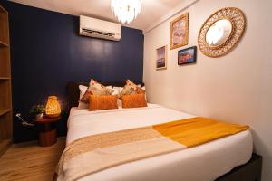 爱妮岛Dockyard by Araw Residences的一间卧室配有一张带橙色枕头的大床