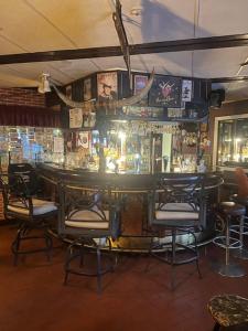 a bar in a restaurant with chairs around it at Gasthaus.himanka in Himanka