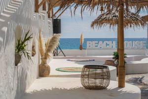 a patio with a table and chairs and the ocean at Gijang The Beach House in Busan