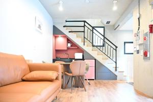a living room with a couch and a staircase at Jeonju Hanok Village Stay Sun Sun in Jeonju +25 photos