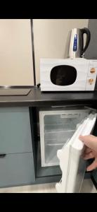 アスタナにあるСтильные апартаменты ЖК Тандауのカウンターの上に置かれた電子レンジ +5枚の写真