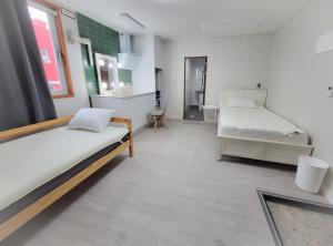 a hospital room with two beds and a kitchen at Jeju Dongmun Residence Hotel in Jeju