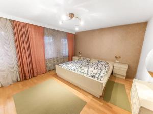a bedroom with a bed and a large window at Gemütliches Terrassenhaus in Degerfelden +2 photos