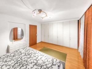 an empty bedroom with a bed and a window at Gemütliches Terrassenhaus in Degerfelden