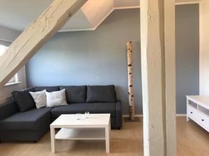 a living room with a couch and a table at Nordic Living - 90m² im nordisch modernen Stil in Flensburg +2 photos