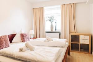 a bedroom with two beds with towels on them at OstseePerle in Solitüde in Flensburg