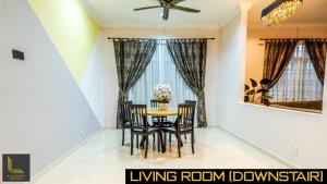 a dining room with a table and chairs at Kota Bharu Bungalow Homestay in Kota Bharu