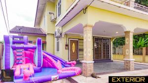 a house with a inflatable playground in front of it at Kota Bharu Bungalow Homestay in Kota Bharu +6 photos