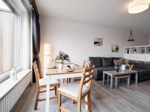 a living room with a table and a couch at Küstenliebe -mit traumhaftem Meerblick und Balkon in Flensburg +12 photos