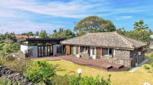 an image of a house with a yard at Chungsoo Inn in Jeju